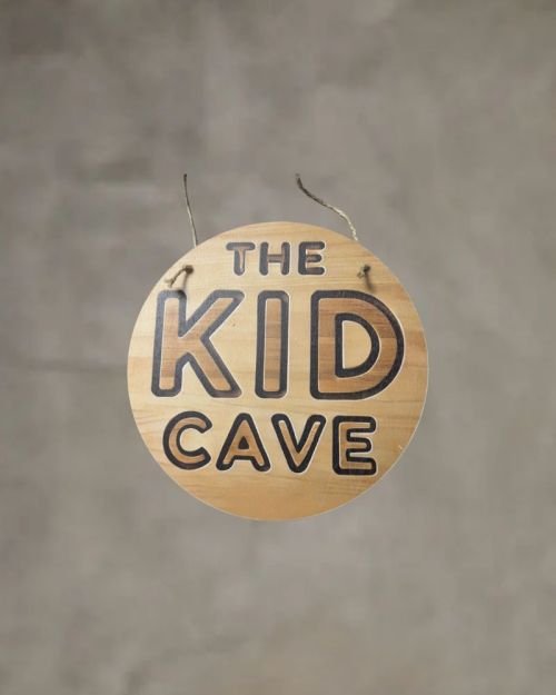 The Kid Cave Sign Printed On Neutral Plywood